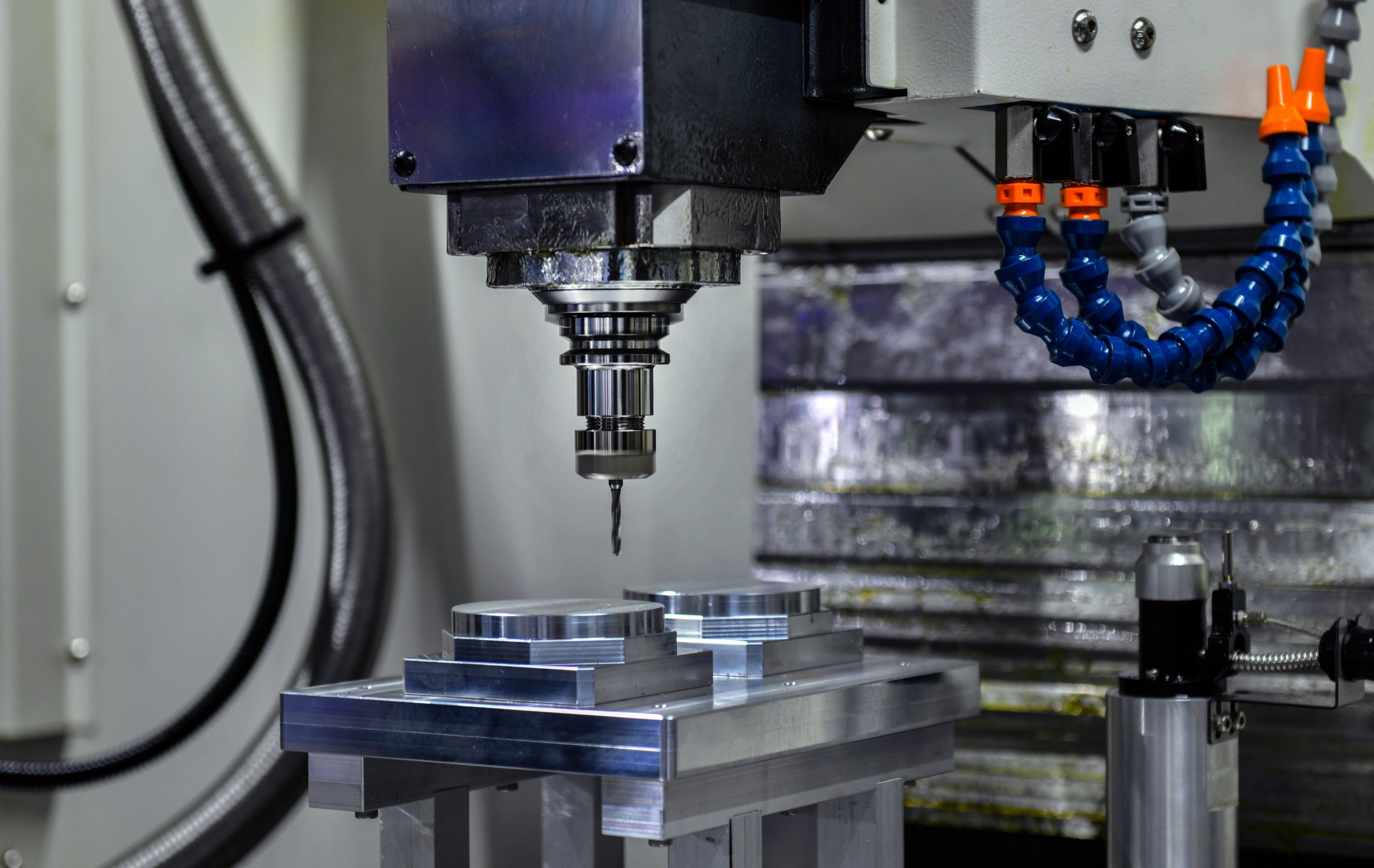 CNC milling spindle above precision metal components