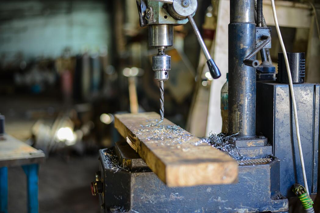 Drill press and metal shavings in a workshop